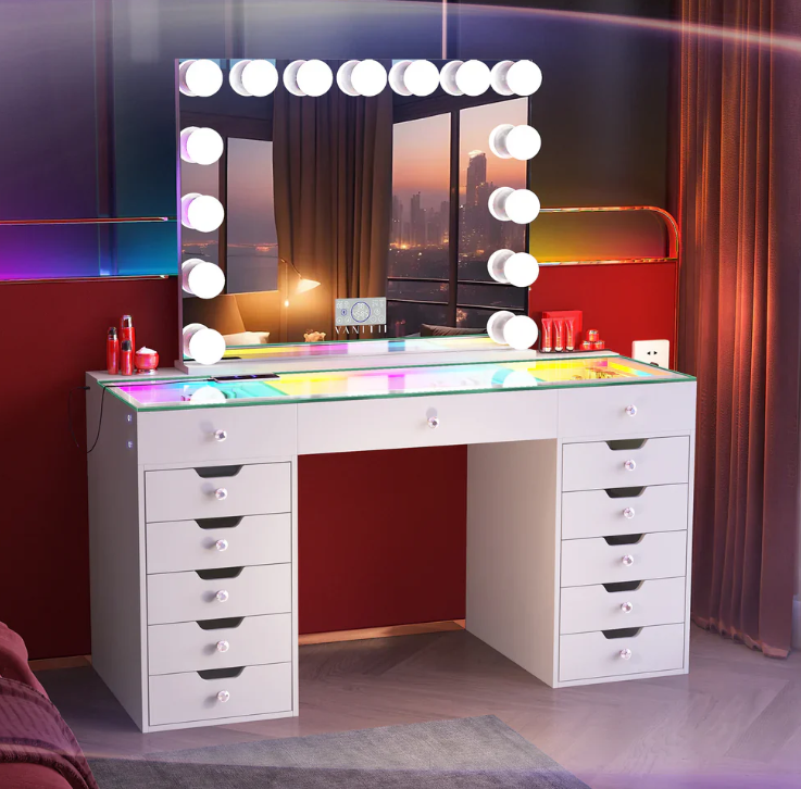 A VANITTI company branded LED vanity set, desk and mirror with frosted exterior bulbs. Vanity desk his interior colorful lighting. Set in a studio location and has some makeup accessories on top of the desk.