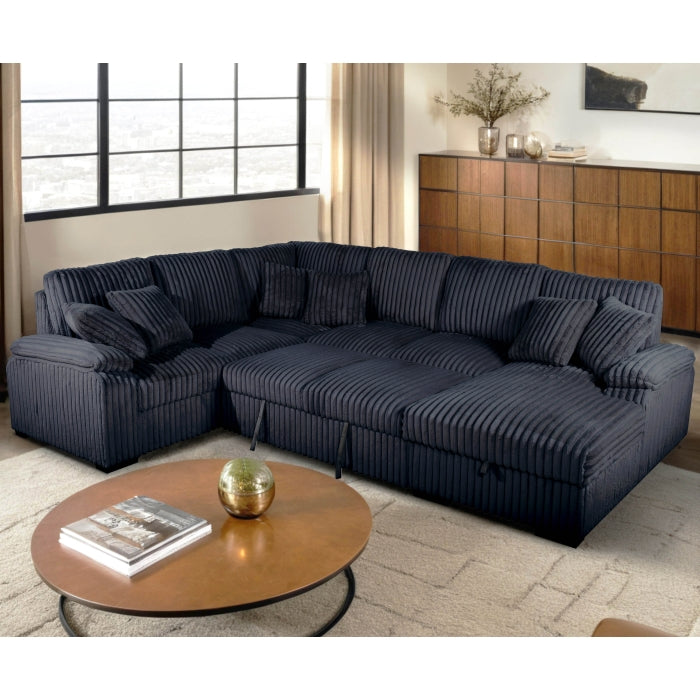 Black sectional sofa in a living room with a coffee table and decorative items.