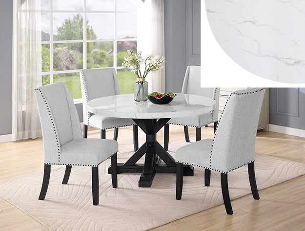 Dining room with a round marble table and four chairs in a well-lit room.