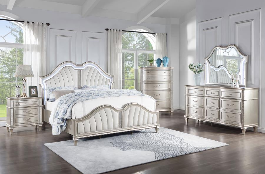 Silver bedroom set with bed, dresser, and mirror in a bright room.