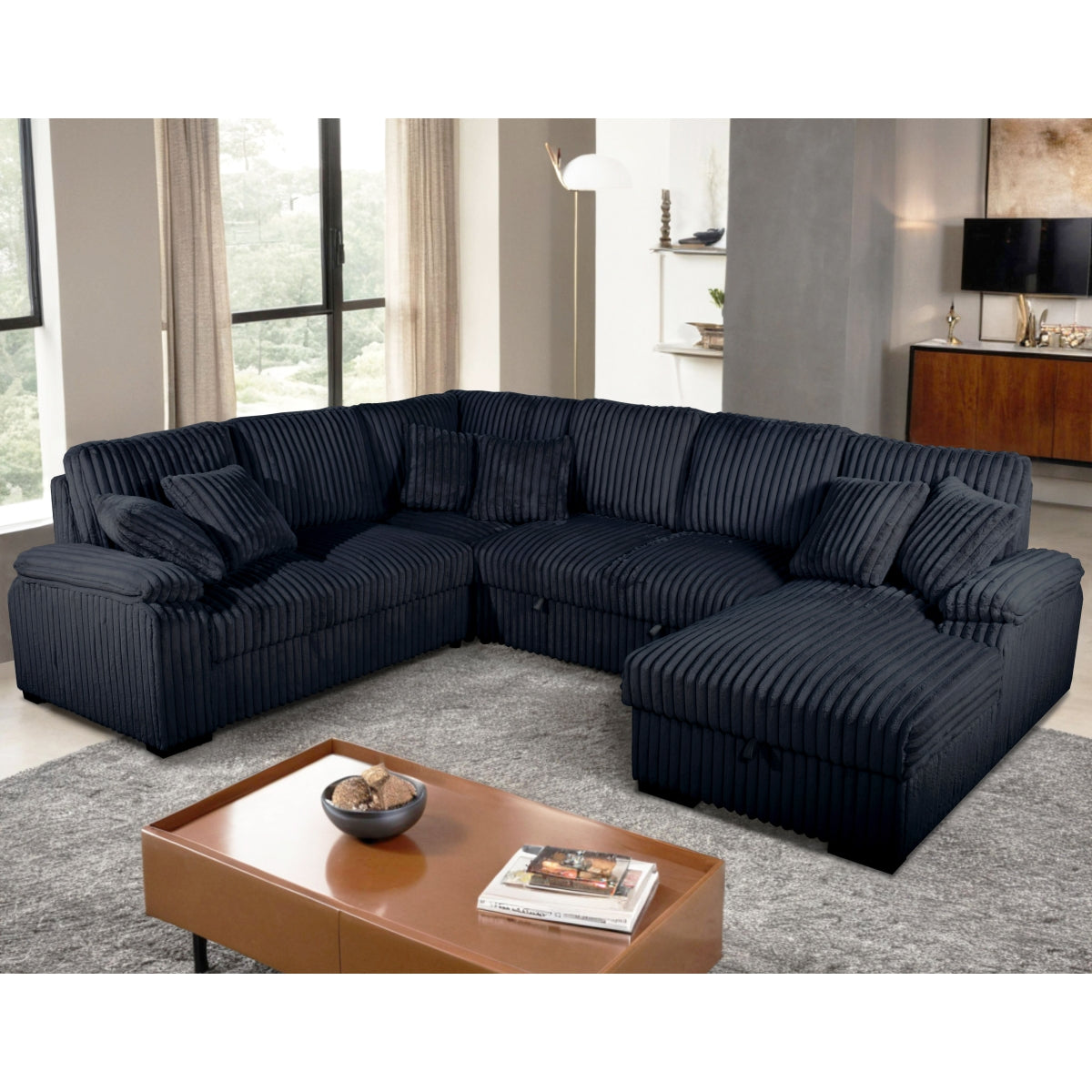 Black sectional sofa in a living room setting with a coffee table.