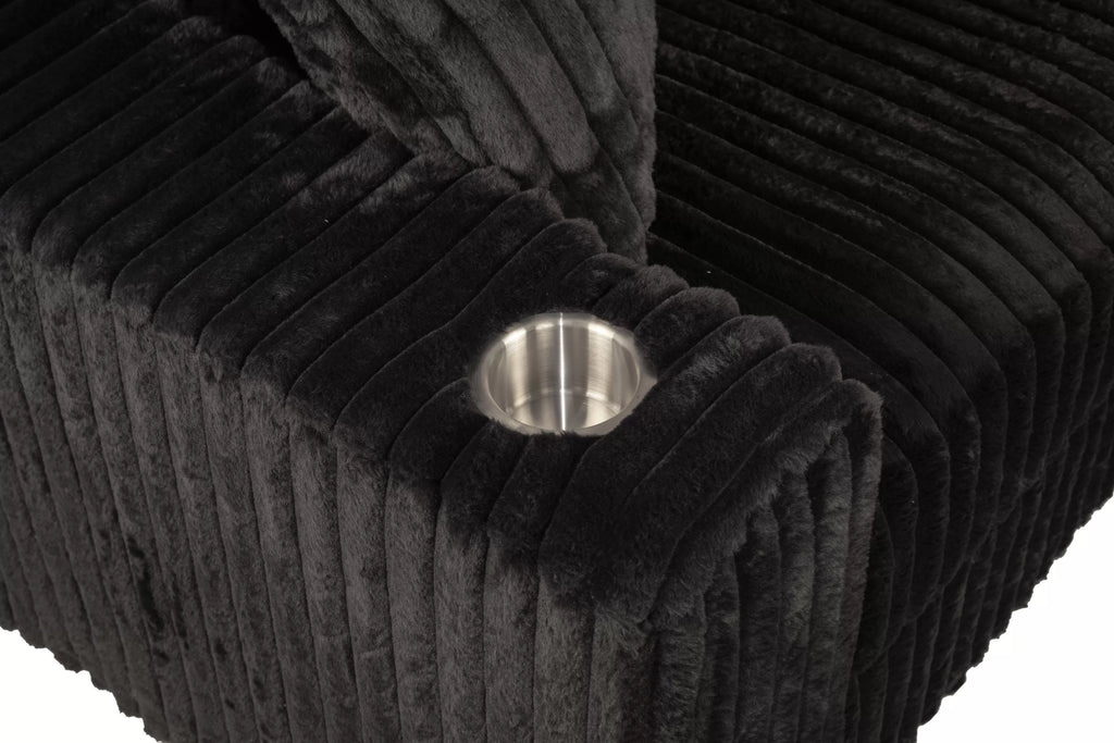 Close up of cup holder on black couch.