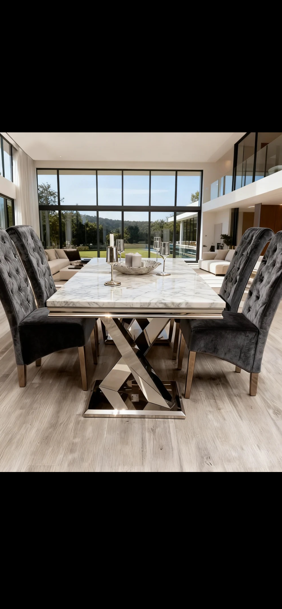 Dining room with a marble table and upholstered chairs in a modern home.