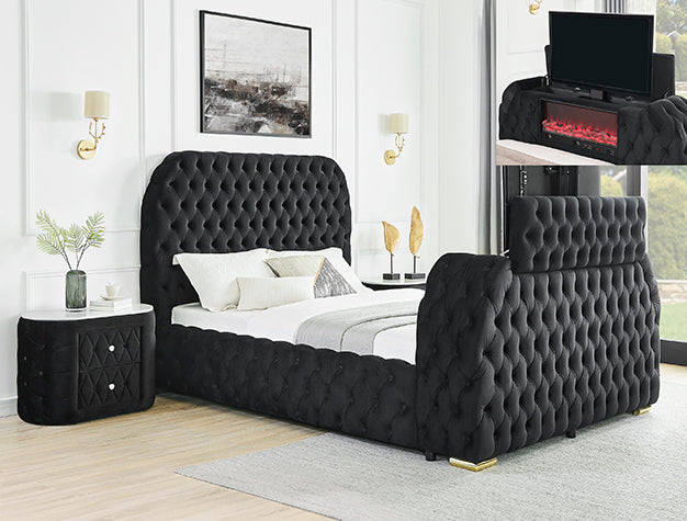 Black tufted bed with fireplace and tv inside bed and white bedding in a bedroom setting.