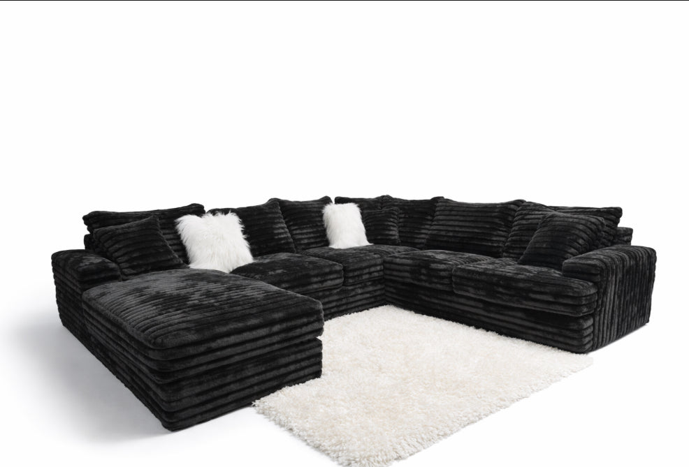 Black sectional sofa on a white background