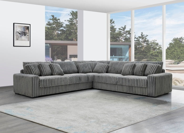 Gray sectional sofa in a modern living room with large windows.