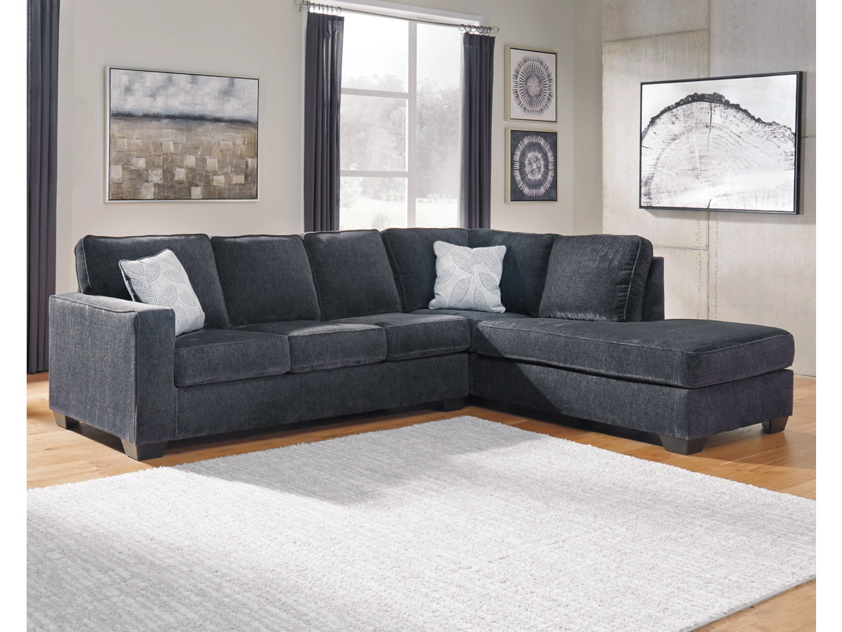 Gray sectional sofa in a living room with decor elements.