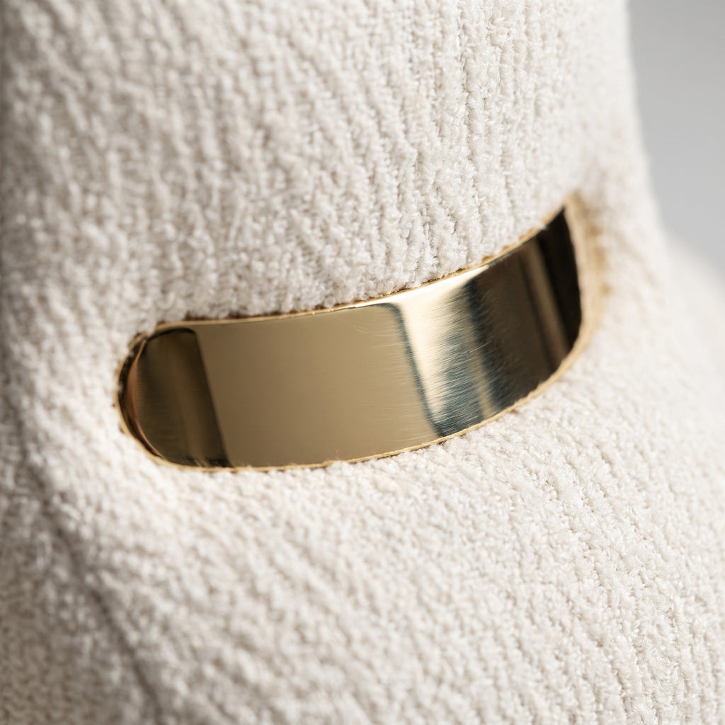 Gold bracelet on a textured white surface