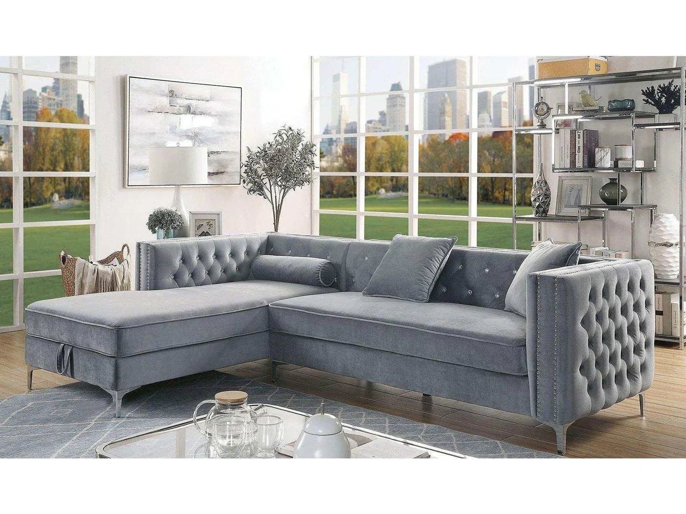 Gray sectional sofa in a living room with large windows and cityscape view.