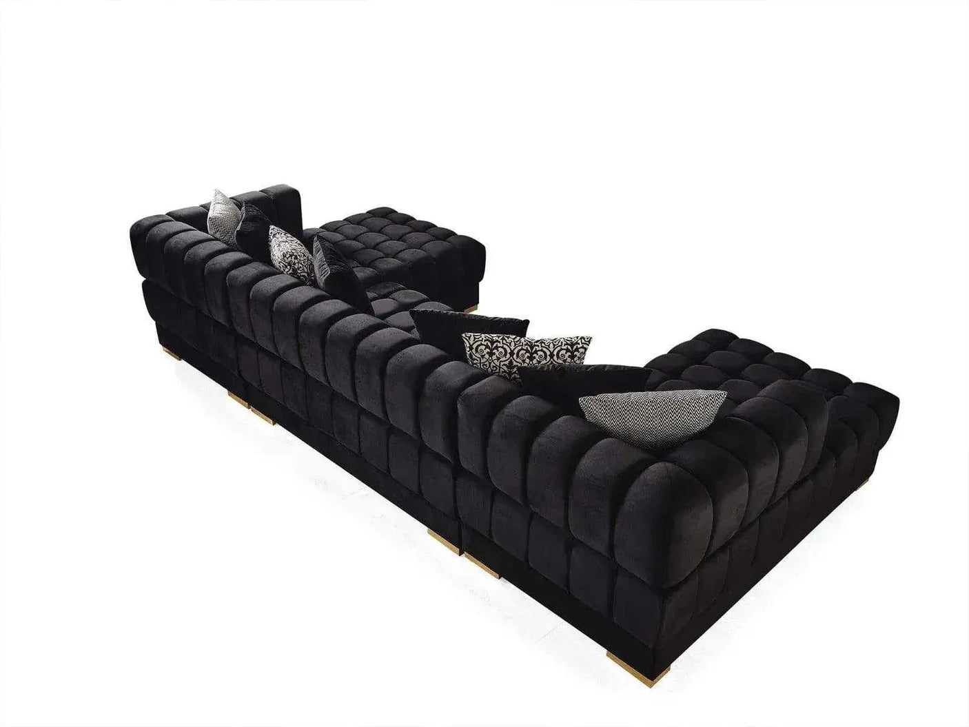 Black tufted sofa with decorative pillows on a white background