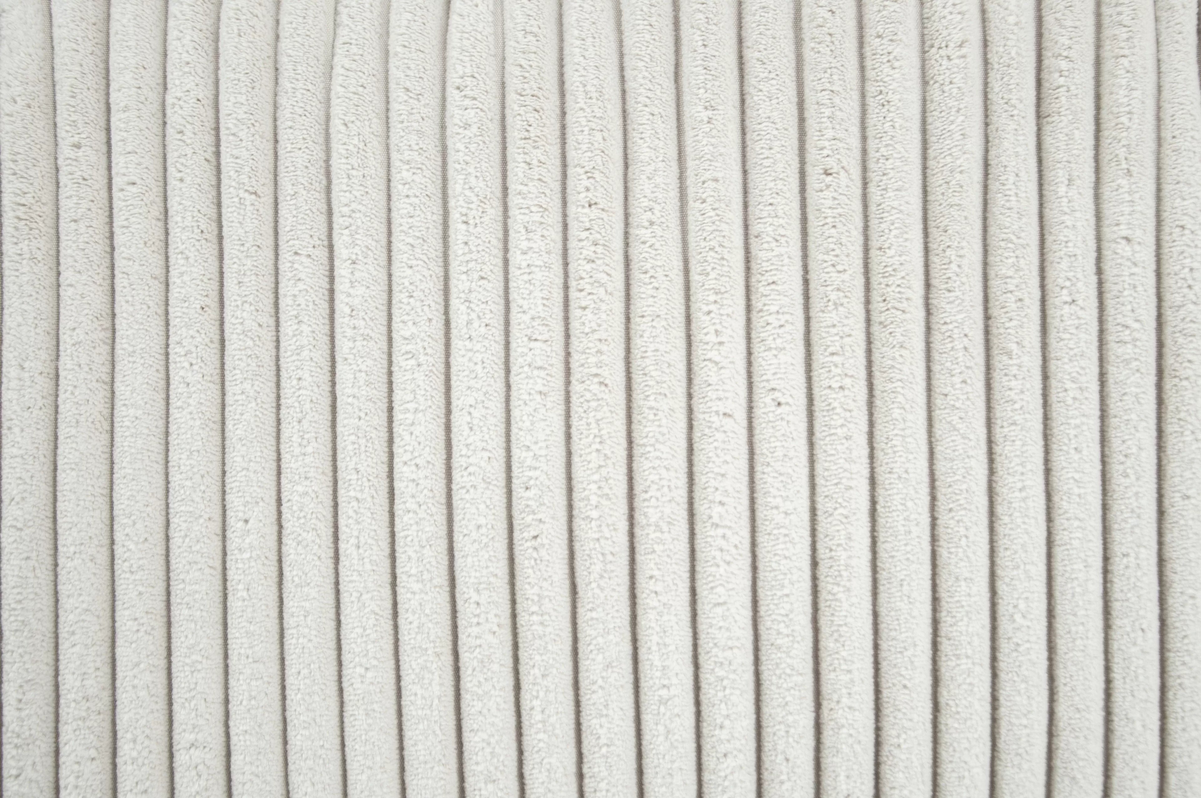 Close-up of textured white fabric with a subtle pattern