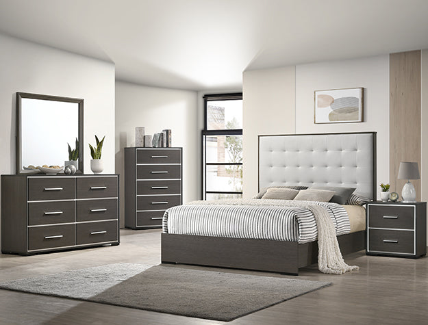 Modern bedroom set with gray furniture and a bed in a well-lit room.