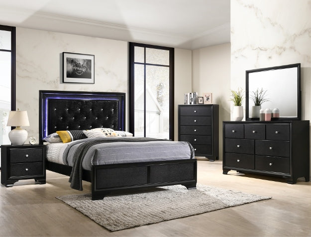 Black bedroom furniture set with bed, dresser, and nightstands in a room.