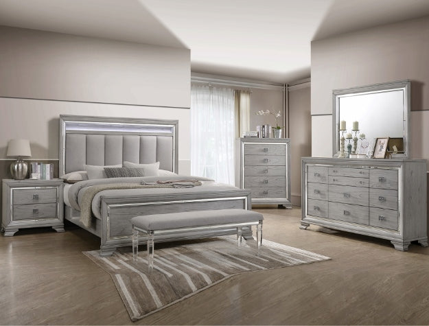 Silver bedroom furniture set with bed, nightstands, dresser, and mirror in a room.