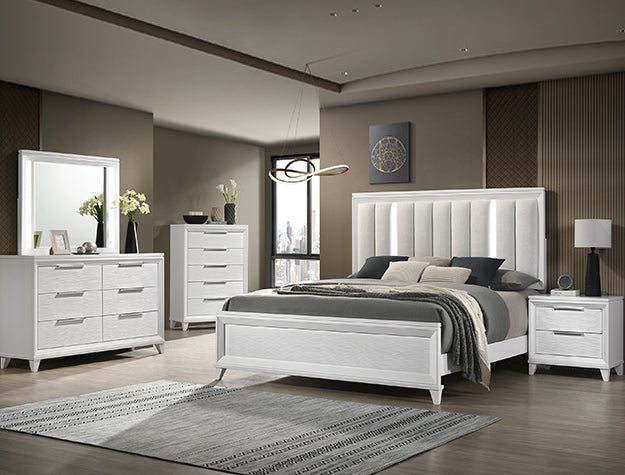 Modern bedroom with white furniture set including bed, dresser, and nightstands.