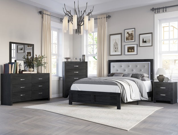 Modern bedroom set with black furniture, bed, and decor in a well-lit room.
