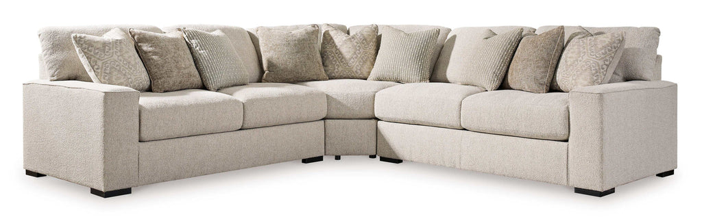 Beige sectional sofa with multiple cushions on a white background