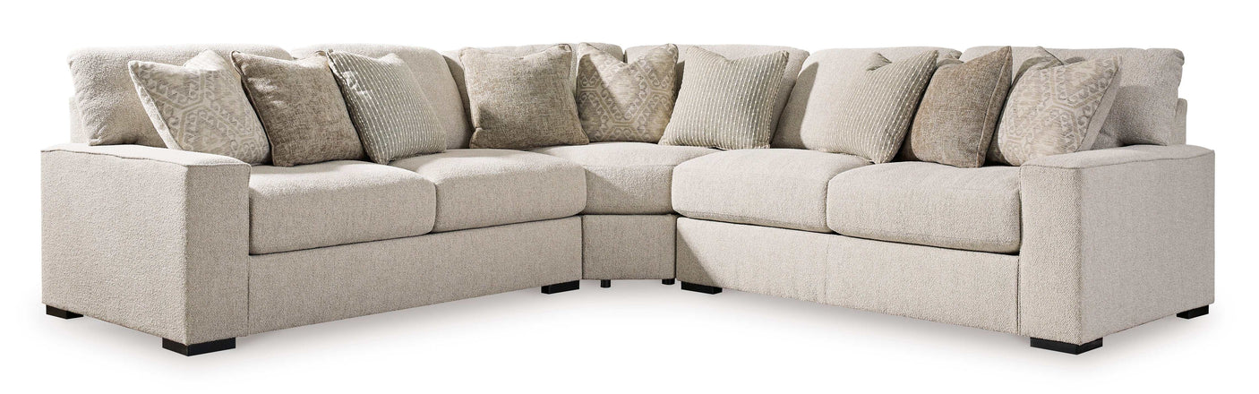 Beige sectional sofa with multiple cushions on a white background