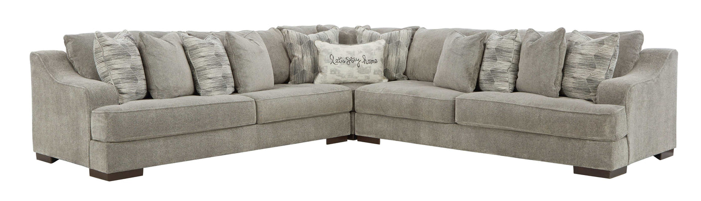 Gray sectional sofa with patterned cushions on a white background