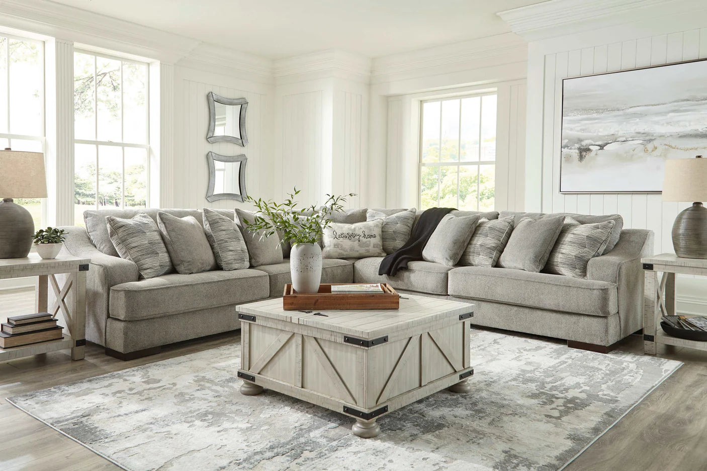 Living room with gray sectional sofa, coffee table, and decorative elements.