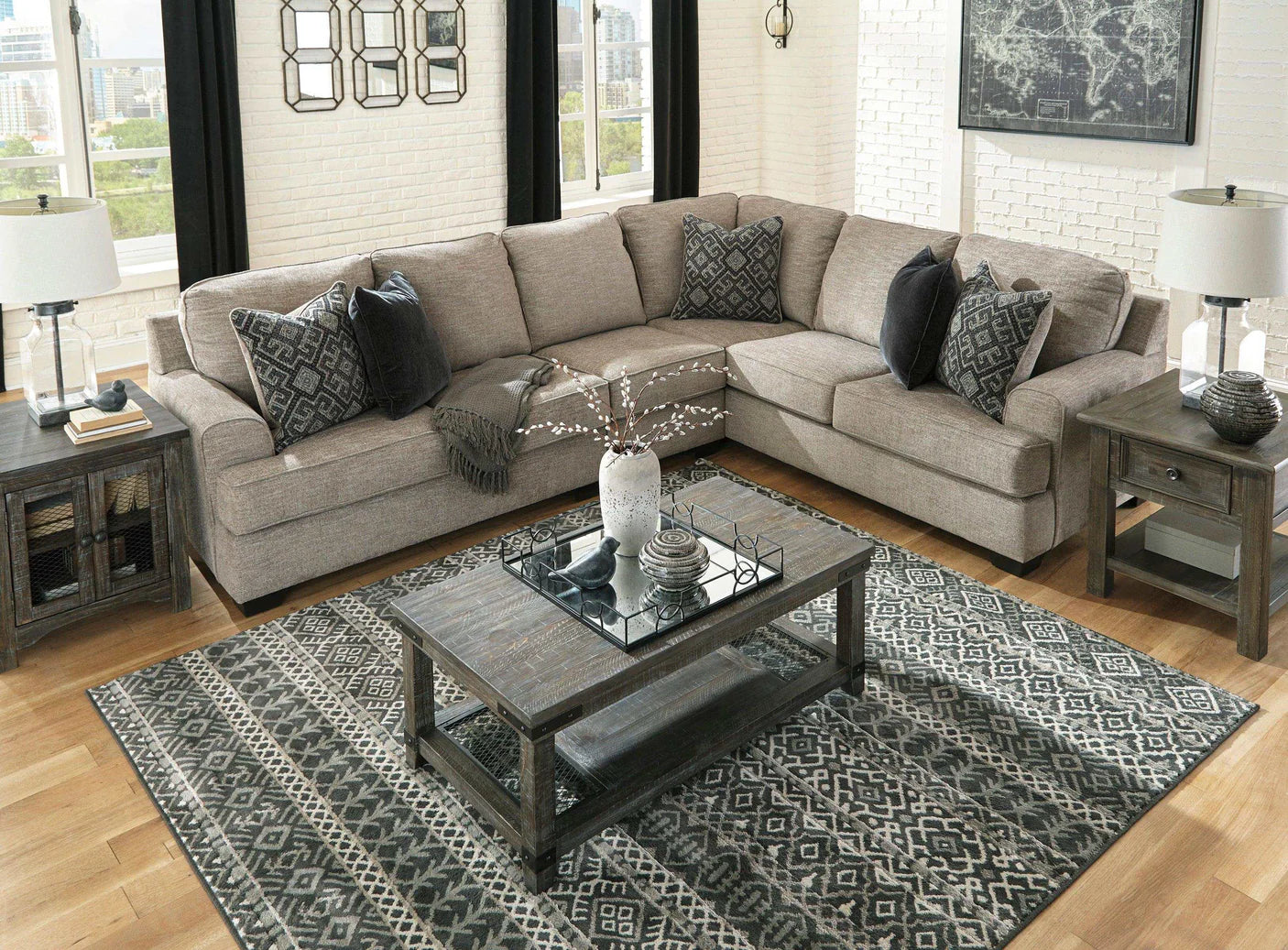 Living room with a gray sectional sofa, coffee table, and decorative pillows.