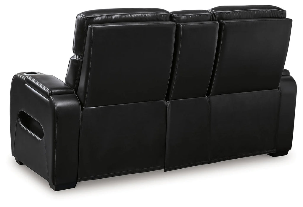 Back of a black reclining loveseat set in a white background.