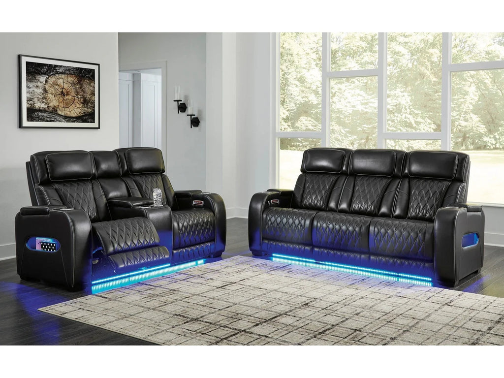 Black reclining sofa loveseat with blue led lighting set in a modern living room.