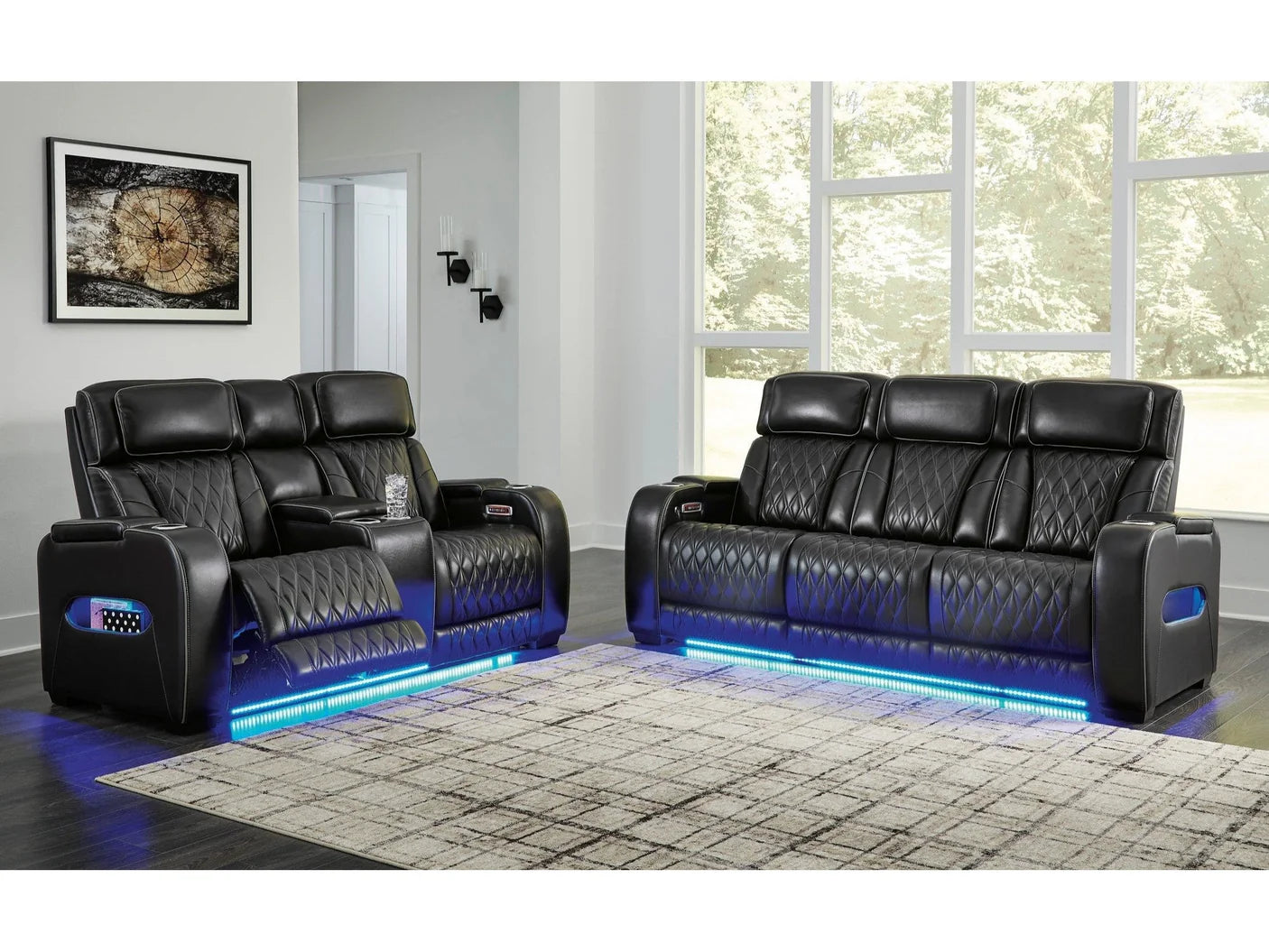 Black reclining sofa loveseat with blue led lighting set in a modern living room.