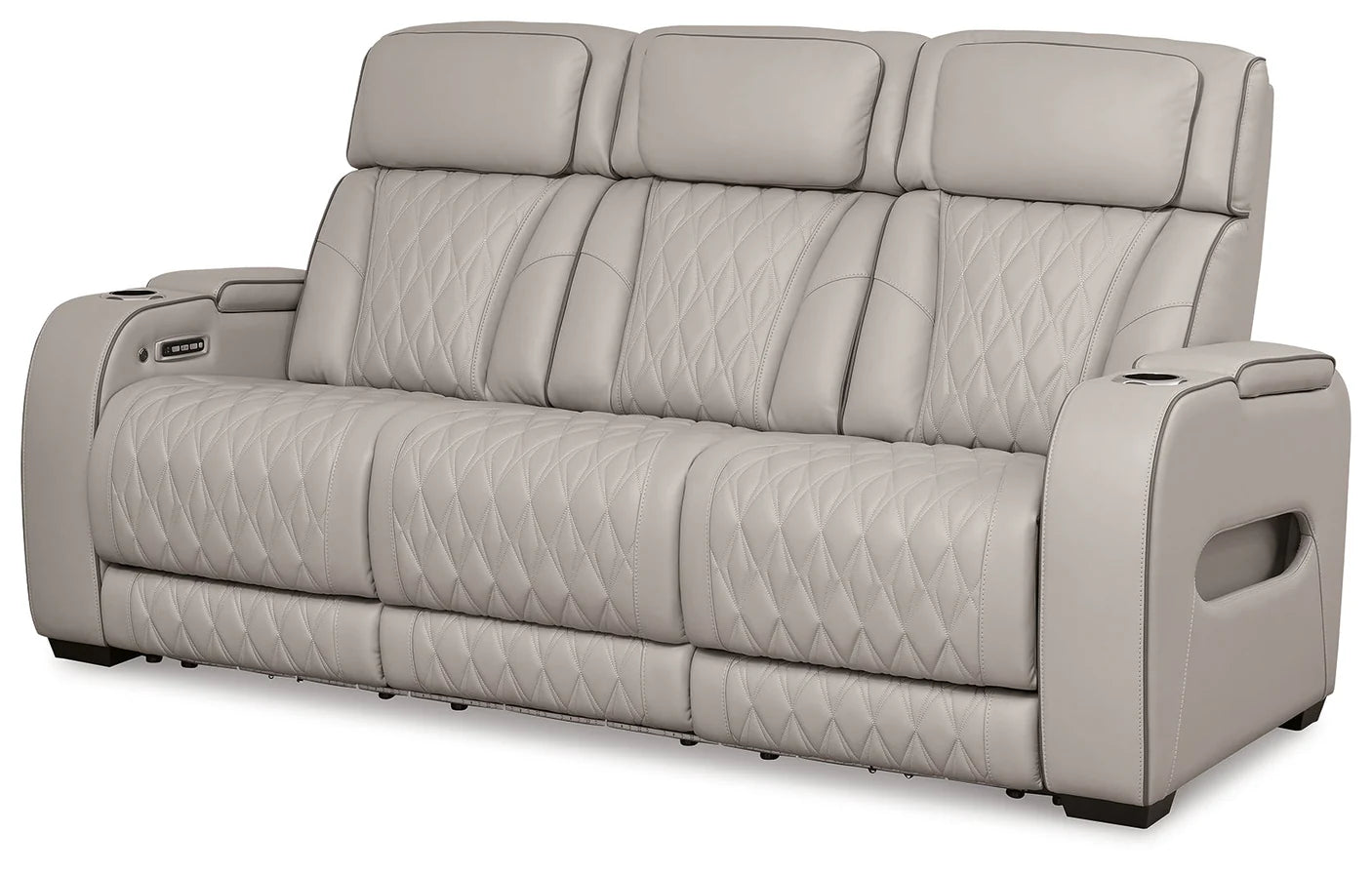 Gray sofa with quilted pattern on a white background