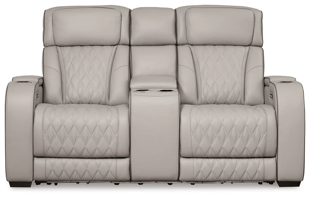 Gray recliner sofa with quilted pattern on a white background