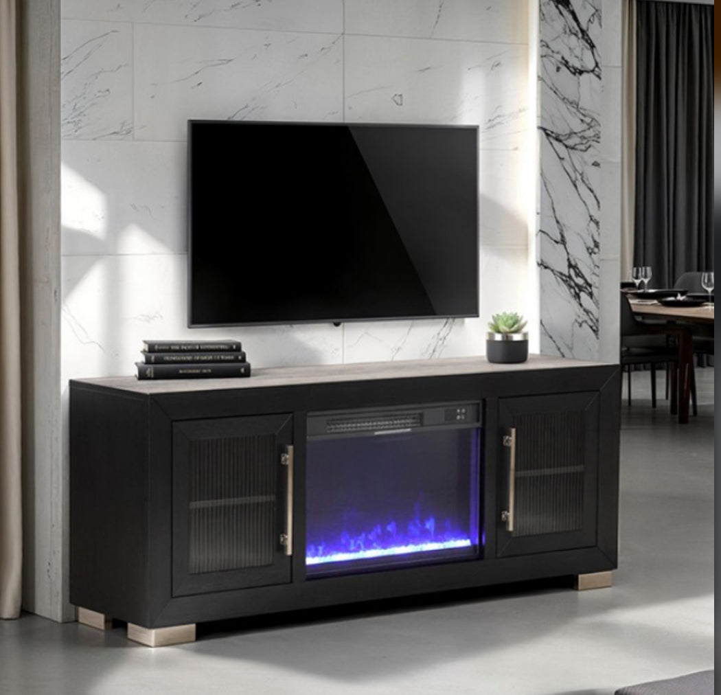 Black entertainment console with built-in fireplace and TV above in a room setting.