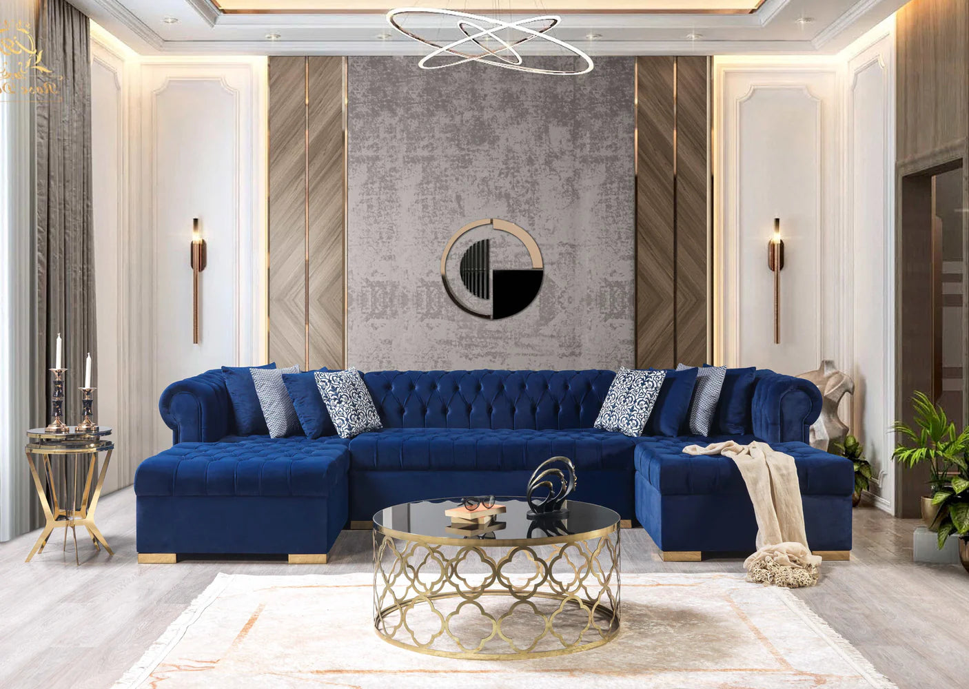 Modern living room with a blue sectional sofa, gold coffee table, and decorative wall art.
