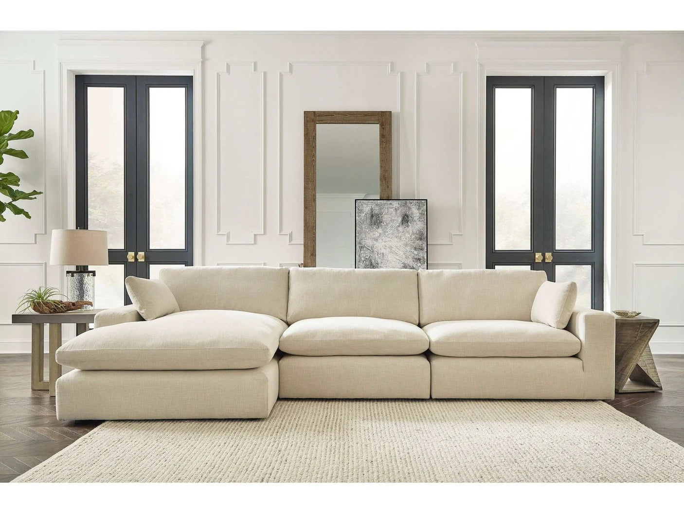 Beige sectional sofa in a modern living room with neutral decor.