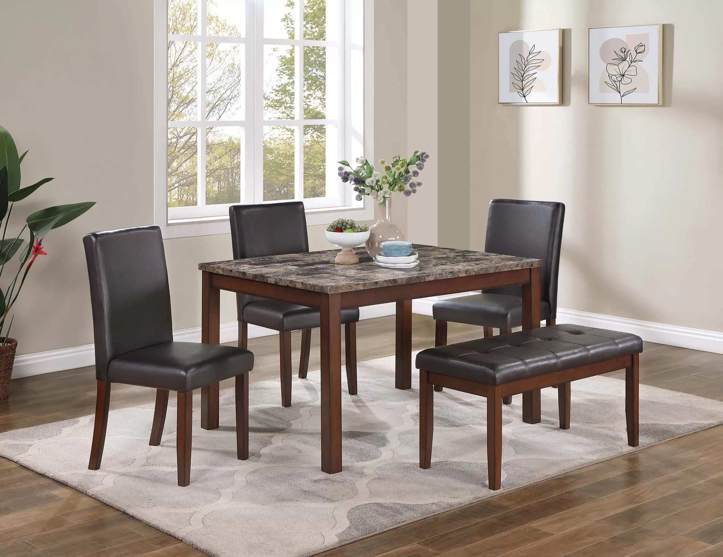 Dining room set with a table and four chairs in a well-lit room.