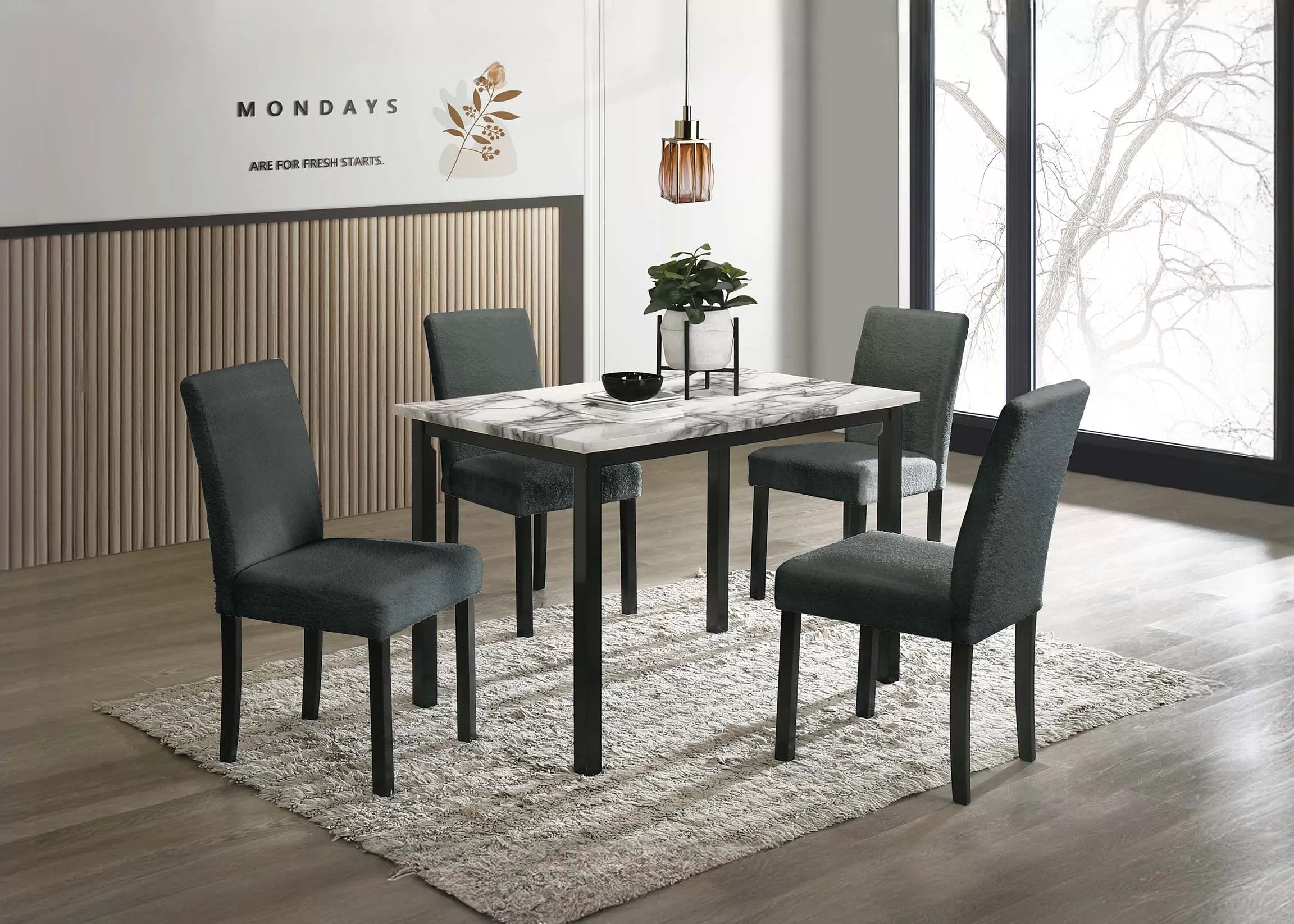 Dining room setup with a marble table and four gray chairs in a modern interior.