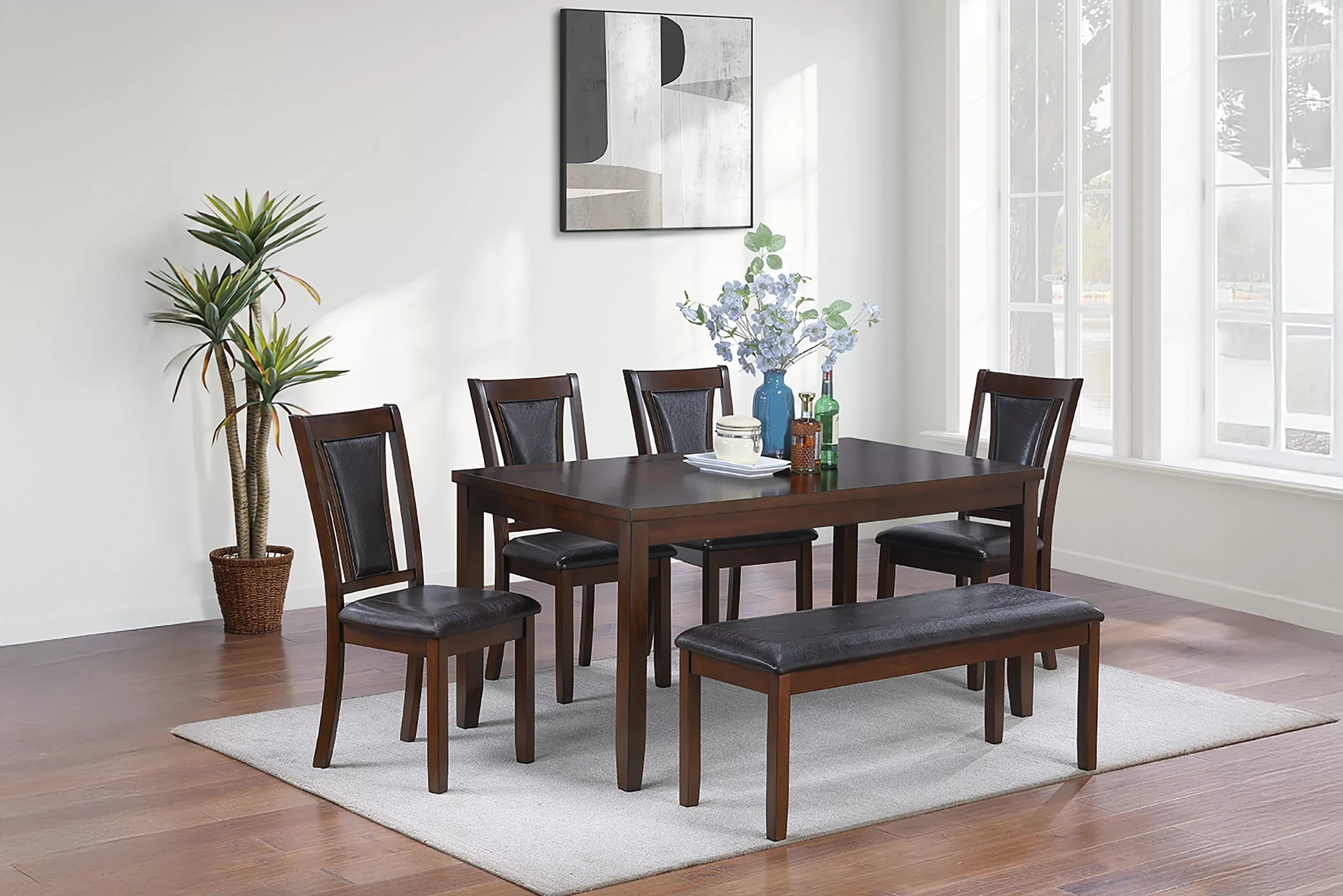 Dining room set with wooden table and chairs in a well-lit room.
