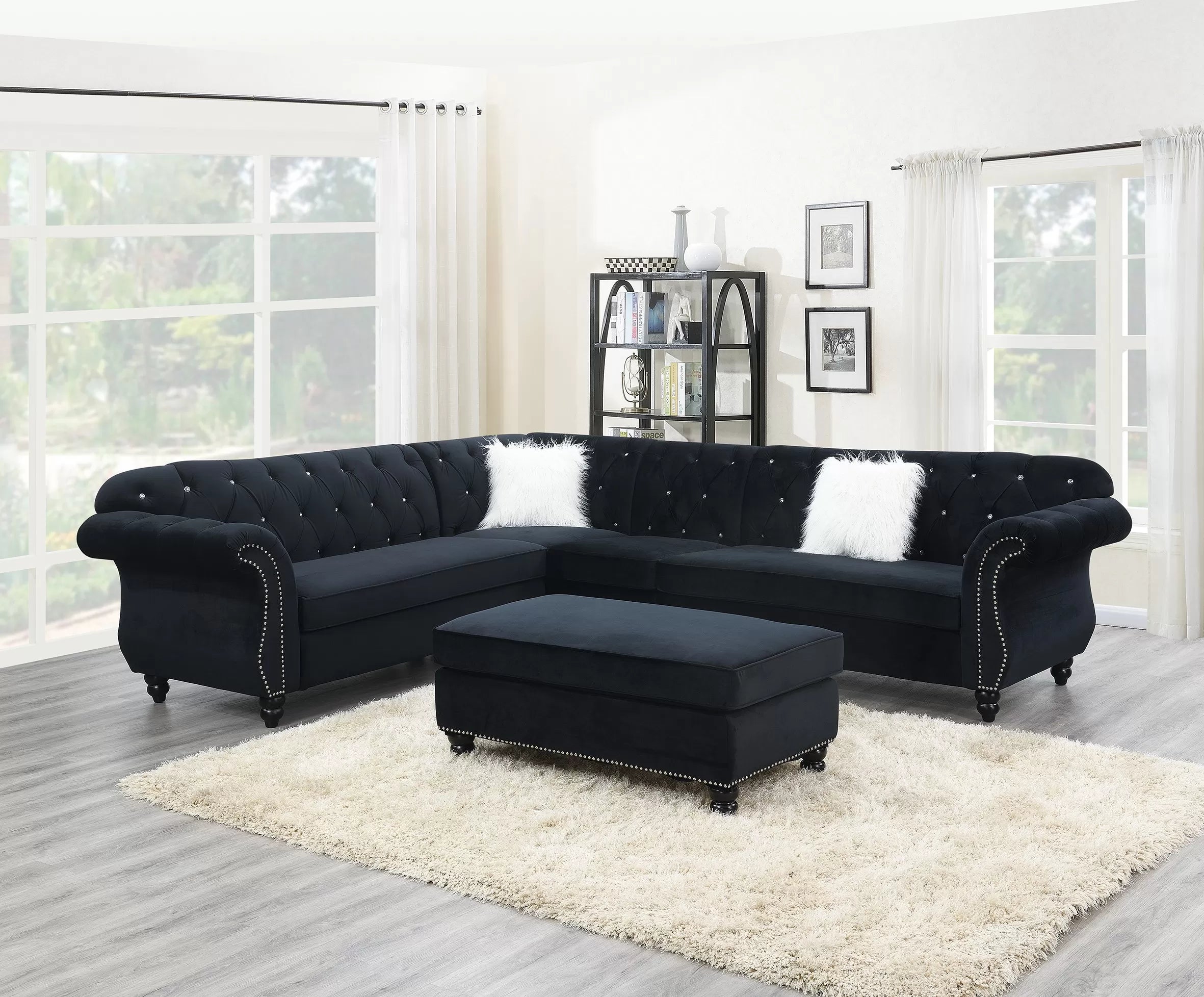 Black sectional sofa with ottoman in a living room setting