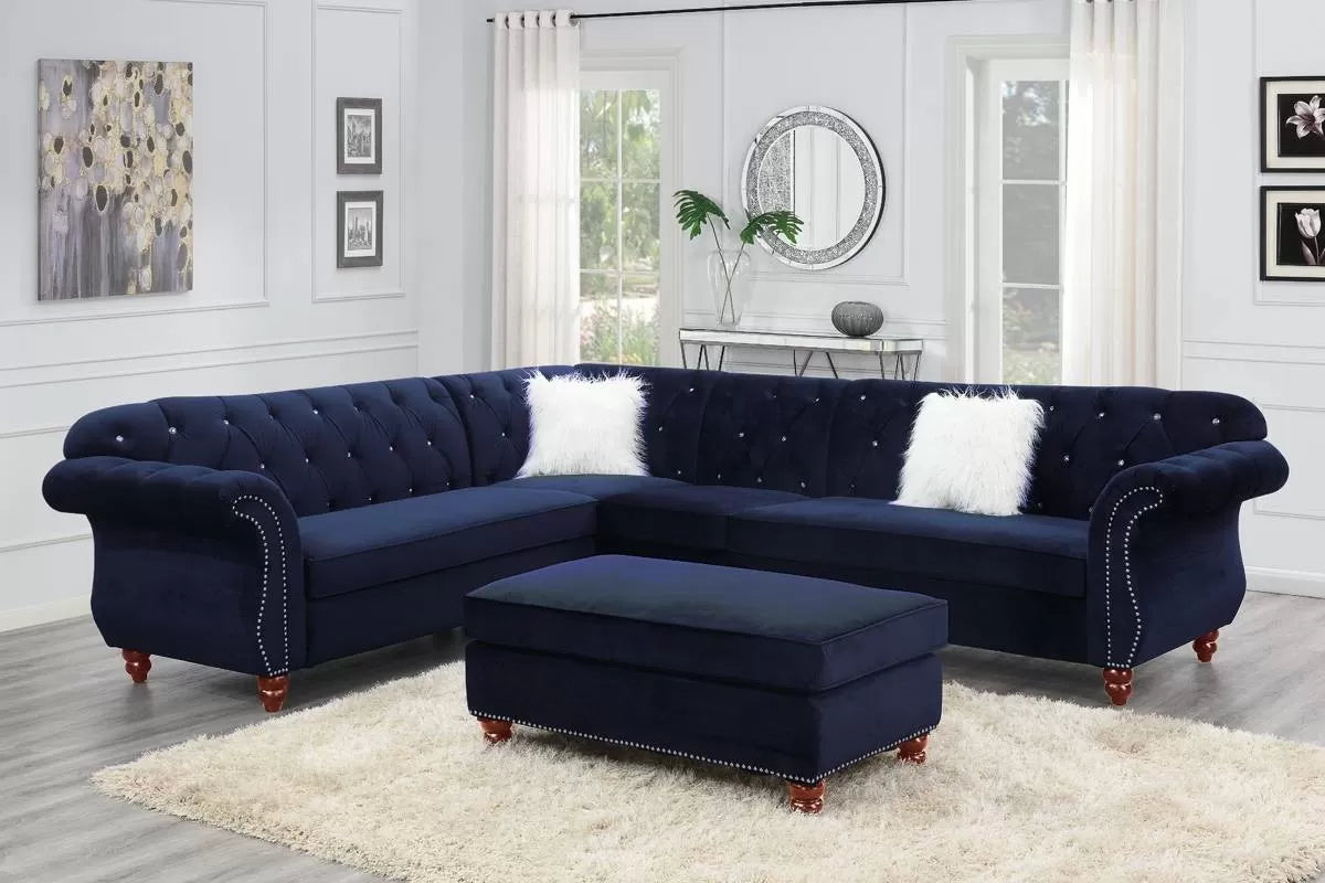 Navy blue indigo sectional sofa with white pillows in a living room setting.