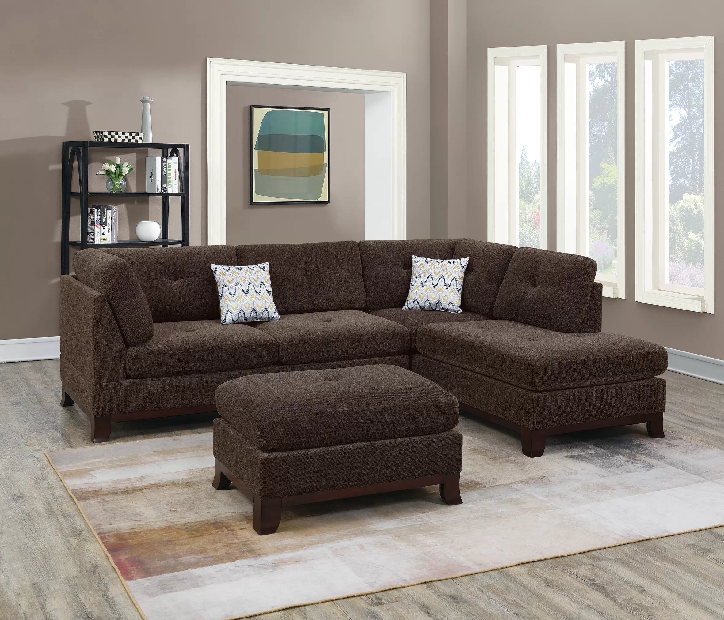 Brown sectional sofa with ottoman in a living room setting.