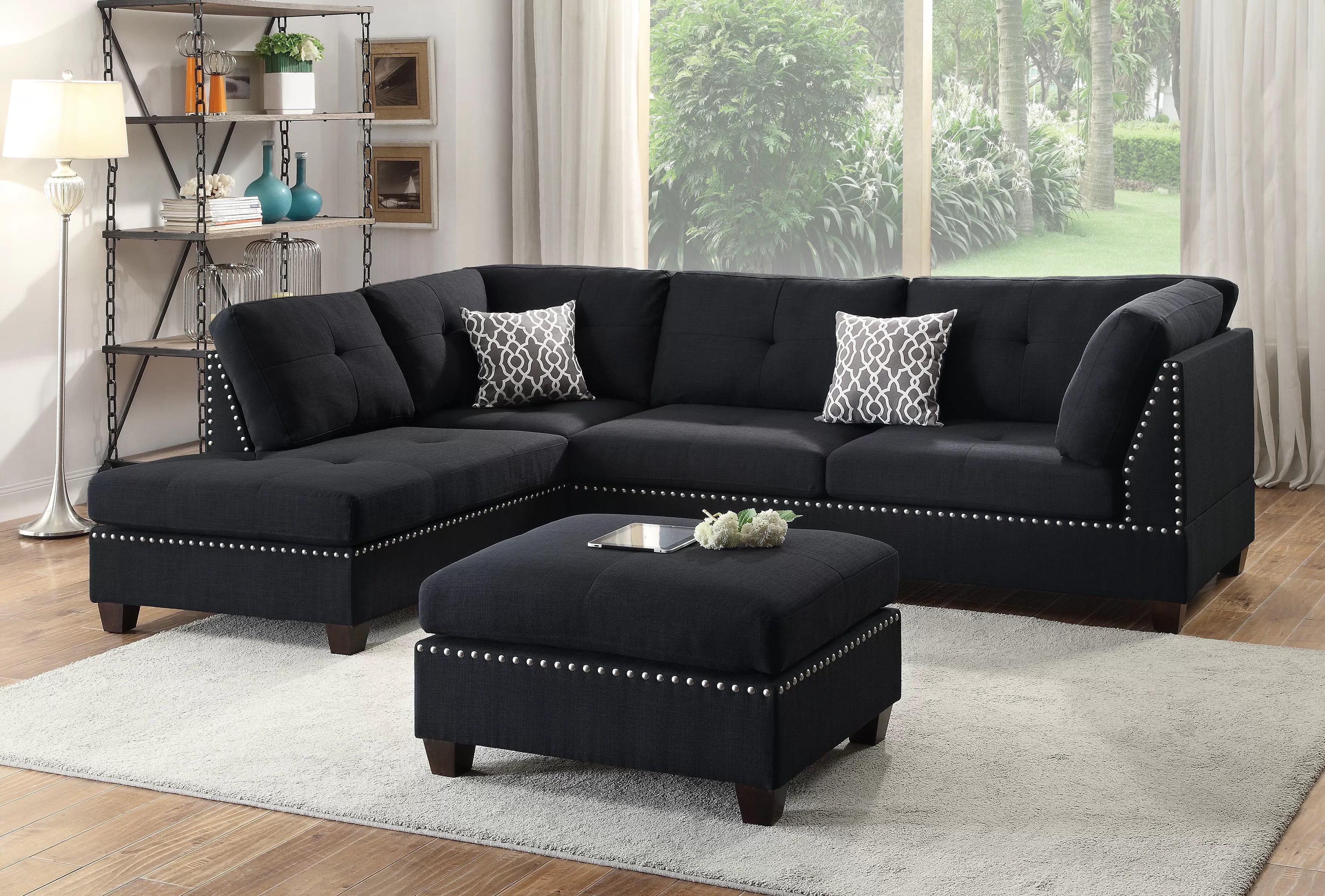 Black sectional sofa with ottoman in a living room setting