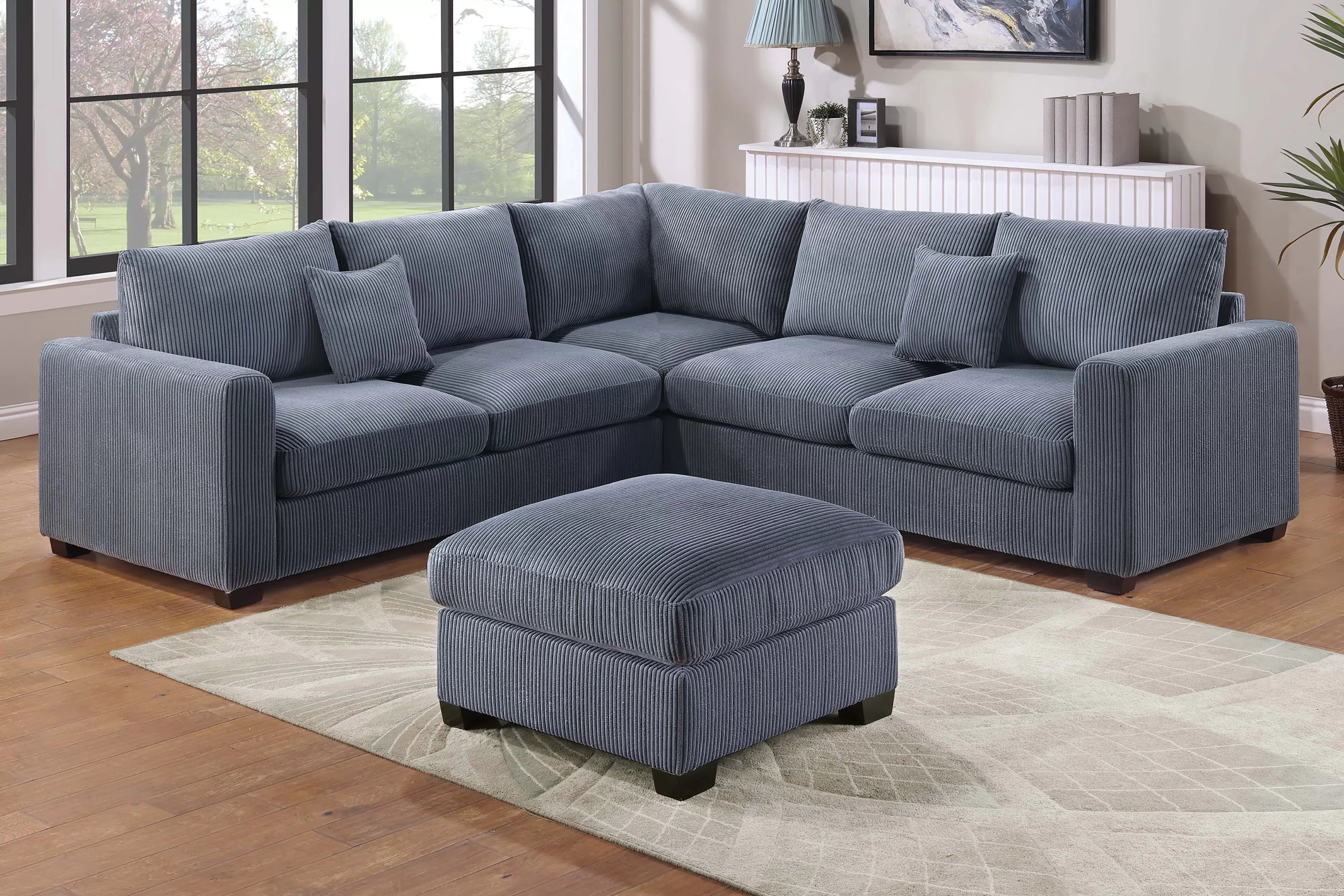 Gray sectional sofa with ottoman in a living room setting