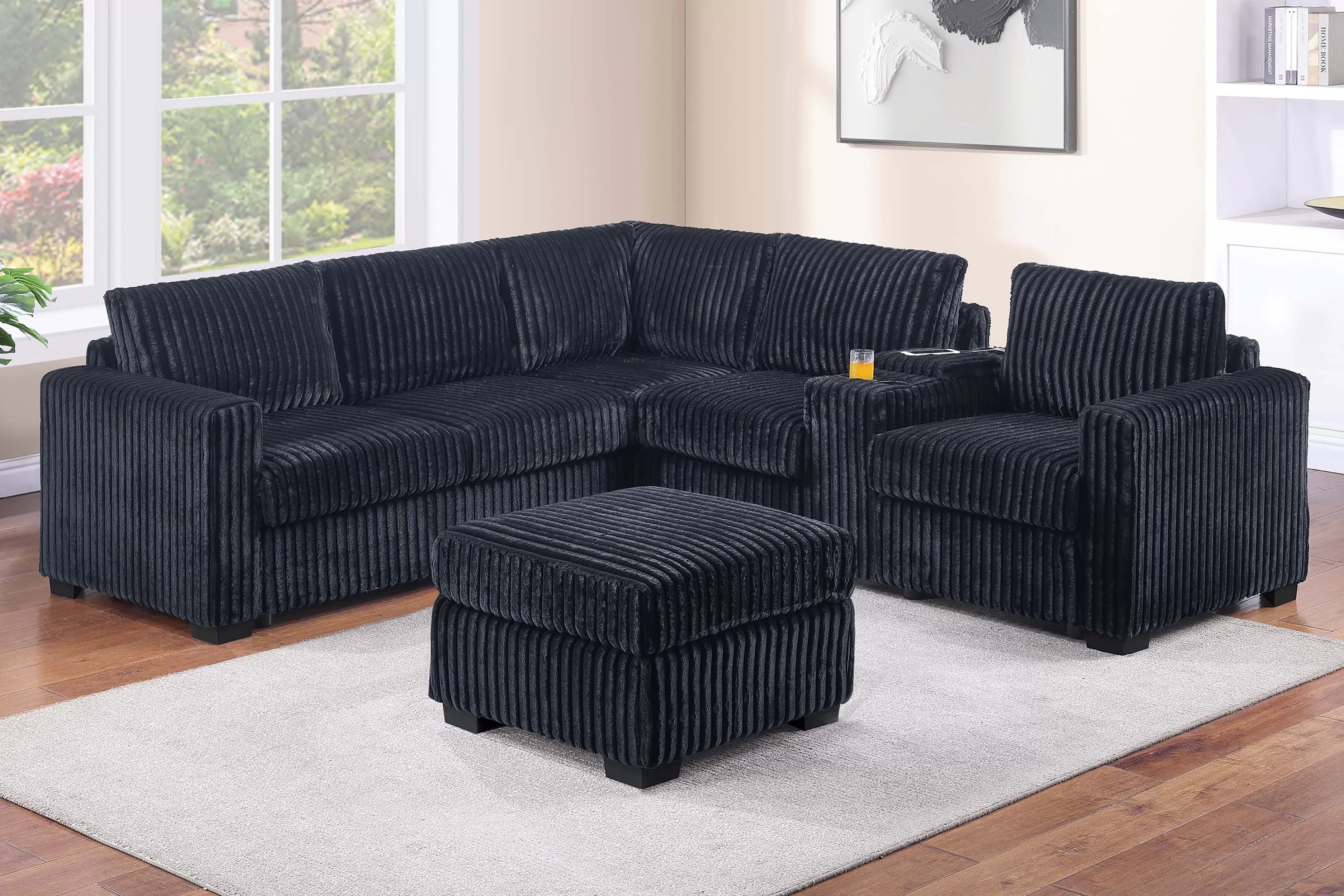Black sectional sofa with ottoman in a living room setting