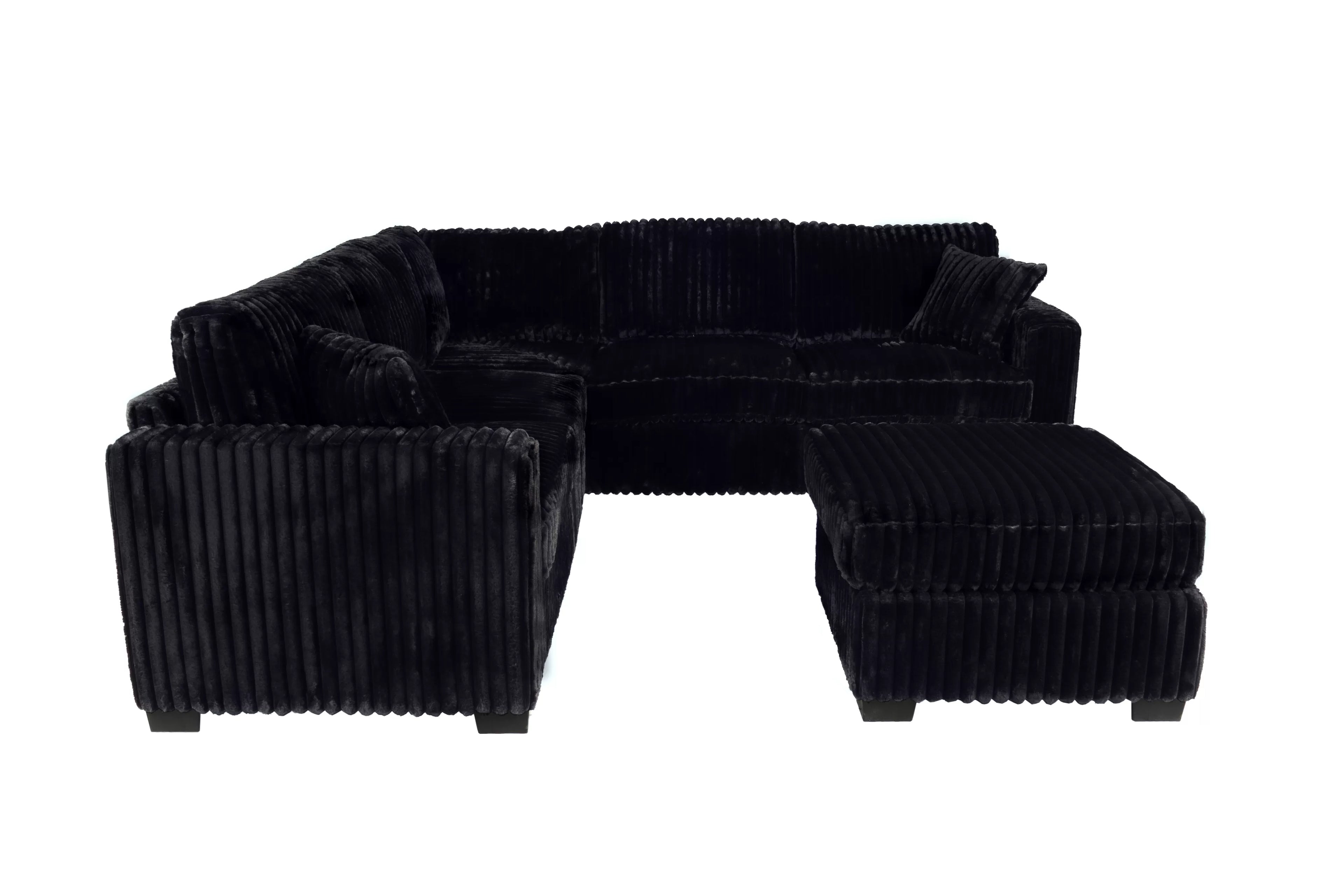 Black ribbed sectional sofa with ottoman on a white background