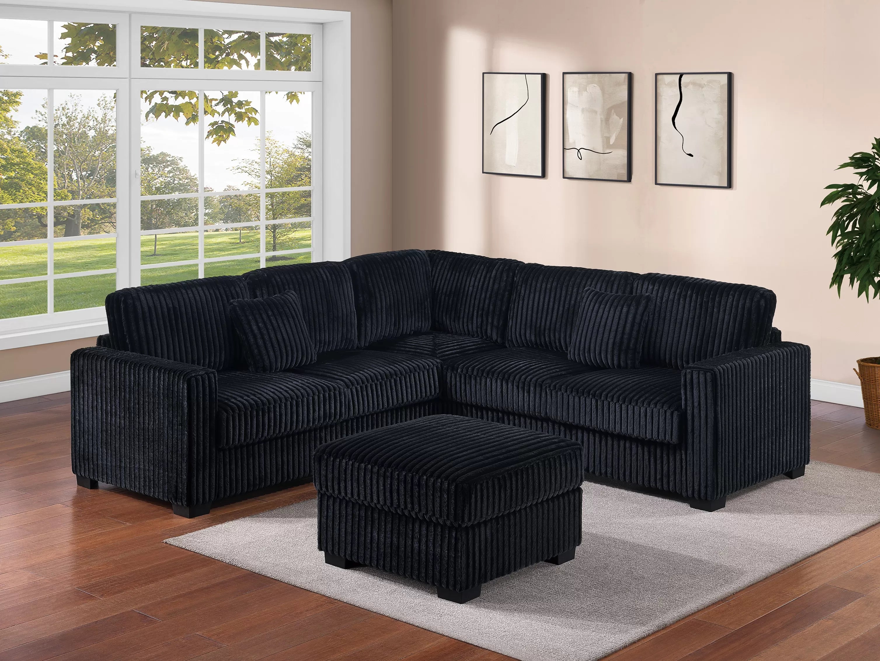 Black sectional sofa with ottoman in a living room setting