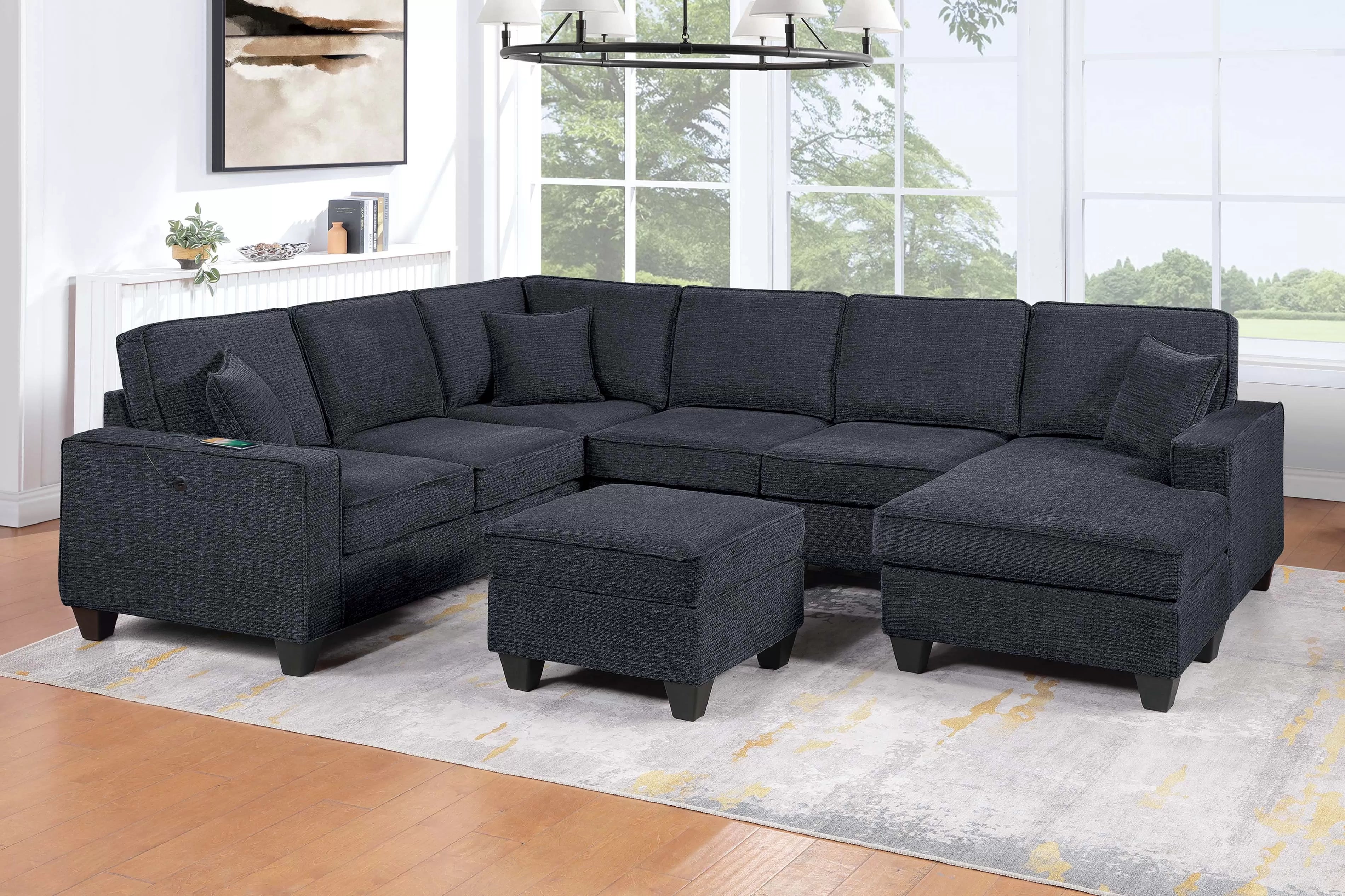 Gray sectional sofa with ottoman in a living room setting