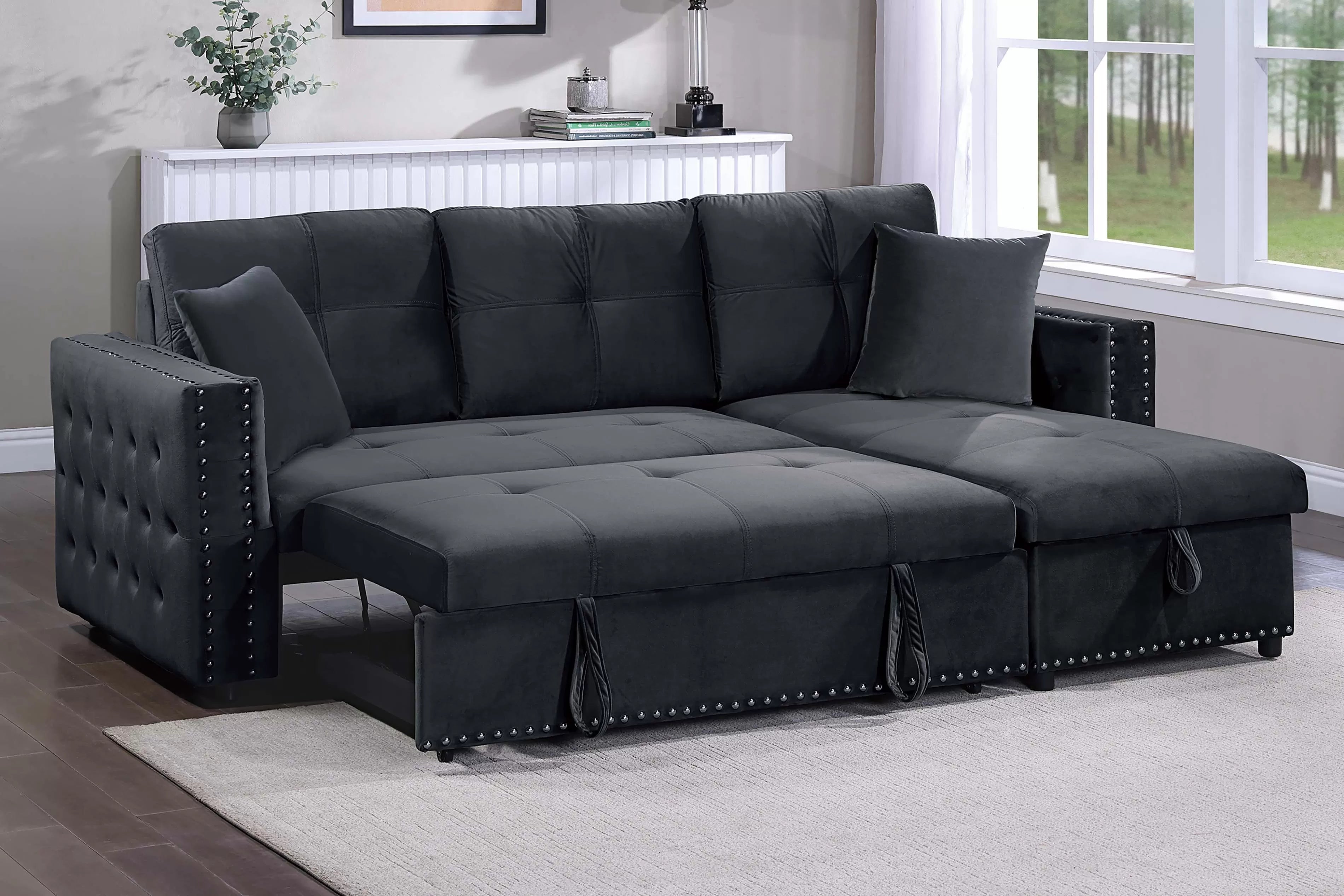 Gray sectional sofa with tufted backrests in a living room setting.