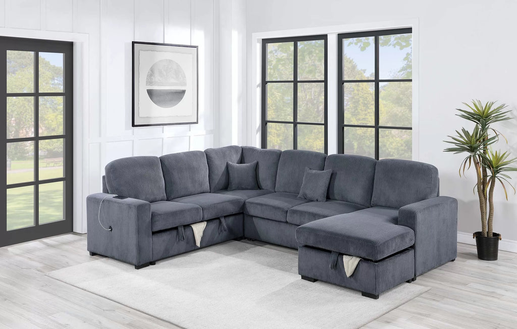 Gray sectional sofa in a living room with large windows and a plant.