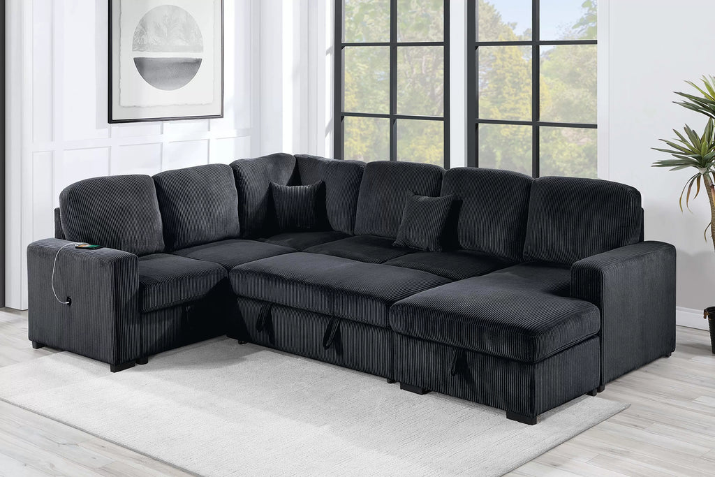Gray sectional sofa in a living room with large windows and a plant.