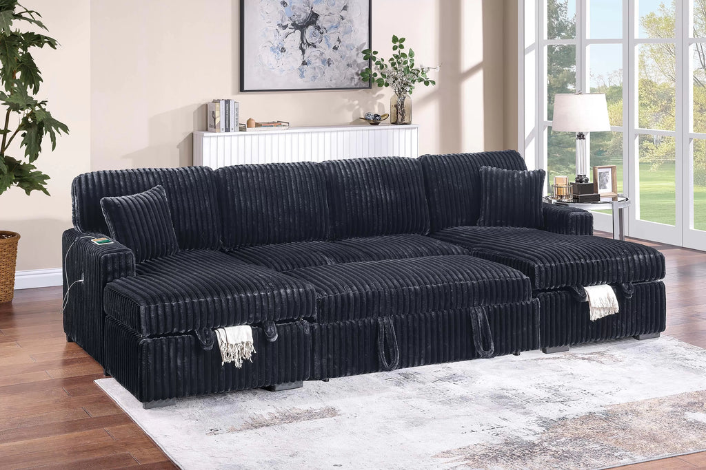 Black sectional sofa with pullout extended in a living room setting with decor elements.