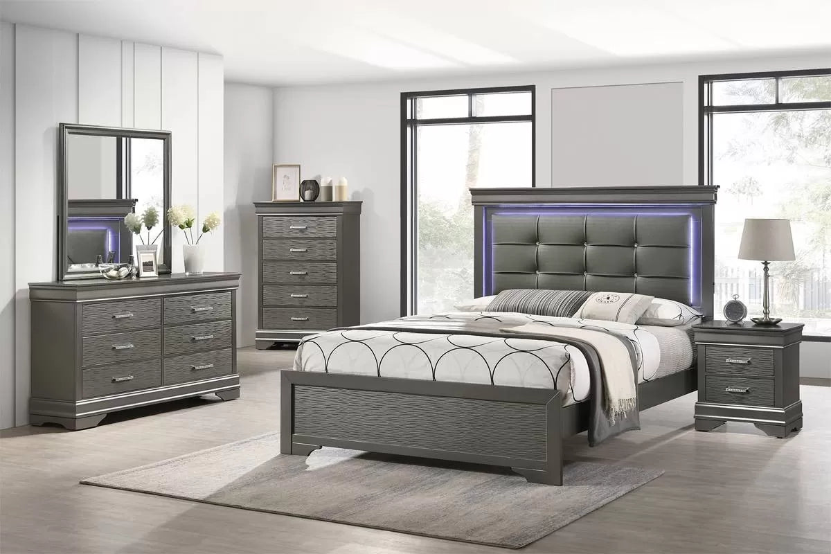 Gray bedroom set with bed, dresser, mirror, and nightstands in a room with large windows.